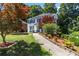 Beautiful two-story home with lush landscaping and a charming walkway leading to the front door at 4909 Glenwhite Dr, Duluth, GA 30096