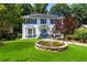 Charming two-story home with a well-manicured lawn, blue accents, and a decorative front pond at 4909 Glenwhite Dr, Duluth, GA 30096