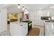 Modern kitchen with an island, white cabinets, gold hardware, and stainless steel appliances at 4909 Glenwhite Dr, Duluth, GA 30096