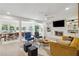 Open-concept living room with stylish furnishings, a cozy fireplace, and seamless access to the dining area at 4909 Glenwhite Dr, Duluth, GA 30096