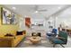 Bright living room with a yellow sofa, modern decor, and an open floor plan leading to the kitchen at 4909 Glenwhite Dr, Duluth, GA 30096