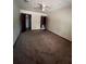 Bedroom with carpet, ceiling fan, and two open doors at 2436 Rex Rd, Ellenwood, GA 30294