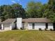 Cozy single-story home with attached garage and partially shaded front yard at 2436 Rex Rd, Ellenwood, GA 30294