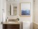 Bathroom with granite countertop, stylish mirror and artwork at 2685 Flagstone Se Dr, Atlanta, GA 30316