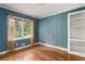 Bedroom featuring blue walls, hardwood floors and a built-in bookcase at 2685 Flagstone Se Dr, Atlanta, GA 30316