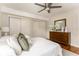 Bright bedroom featuring hardwood floors, ceiling fan and a stylish dresser at 2685 Flagstone Se Dr, Atlanta, GA 30316