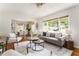 Inviting living area with a gray sofa, stylish decor, and seamless flow into the adjacent dining space at 2685 Flagstone Se Dr, Atlanta, GA 30316
