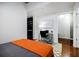 Bright bedroom area with an orange bedspread and work area at 335 W Ponce De Leon Ave # 308, Decatur, GA 30030