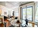 Bright living room with polished concrete ceiling, glass table, and large windows with balcony at 335 W Ponce De Leon Ave # 308, Decatur, GA 30030