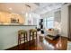 Modern living room view with kitchen bar, concrete ceiling, and ample natural light at 335 W Ponce De Leon Ave # 308, Decatur, GA 30030