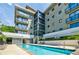 Community pool with a view of the building's exterior at 335 W Ponce De Leon Ave # 308, Decatur, GA 30030