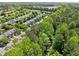An aerial view of homes nestled amongst lush green trees within the Carrington community at 3366 Thornbridge Dr, Powder Springs, GA 30127