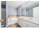 Bathroom featuring a soaking tub, double vanity, and a separate shower stall at 3366 Thornbridge Dr, Powder Springs, GA 30127