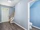 Welcoming entryway with wood-look flooring, staircase, and convenient access to a half bathroom at 3366 Thornbridge Dr, Powder Springs, GA 30127