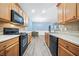 Open kitchen with wood cabinets and laminate countertops at 3366 Thornbridge Dr, Powder Springs, GA 30127
