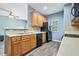 Well-lit kitchen featuring wood cabinets, laminate countertops, and black appliances at 3366 Thornbridge Dr, Powder Springs, GA 30127