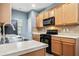 Charming kitchen with wood cabinets, black appliances, and plenty of counter space at 3366 Thornbridge Dr, Powder Springs, GA 30127