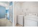 Laundry room featuring a washer, dryer, and a wire rack for storage at 3366 Thornbridge Dr, Powder Springs, GA 30127