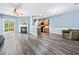 Open-concept living space with fireplace, wood-look floors, and seamless transition to the kitchen at 3366 Thornbridge Dr, Powder Springs, GA 30127