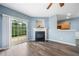 Living room with fireplace, sliding door, and views into the kitchen at 3366 Thornbridge Dr, Powder Springs, GA 30127