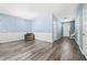 Spacious living room featuring wood floors, wainscoting, and a cozy armchair at 3366 Thornbridge Dr, Powder Springs, GA 30127