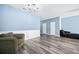 Open living area with hardwood flooring, wainscoting, and comfortable seating at 3366 Thornbridge Dr, Powder Springs, GA 30127