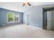 Spacious main bedroom with vaulted ceiling, a ceiling fan, and a large window at 3366 Thornbridge Dr, Powder Springs, GA 30127