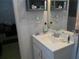 Compact bathroom featuring a white vanity and basic shelving at 770 Starrsville Rd, Covington, GA 30014