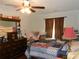 Bedroom with a ceiling fan, dresser, and window with curtains at 770 Starrsville Rd, Covington, GA 30014