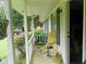 Inviting front porch features chairs, hanging plants, and views of the landscaped yard at 770 Starrsville Rd, Covington, GA 30014