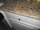 Close-up of beautiful granite countertop with white cabinets at 770 Starrsville Rd, Covington, GA 30014