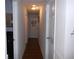 Hallway with hardwood-style flooring, light gray walls, and overhead lighting fixture at 770 Starrsville Rd, Covington, GA 30014