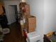 Untidy hallway with boxes and shelves obstructing access to the door at 770 Starrsville Rd, Covington, GA 30014
