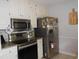 Well-lit kitchen features stainless steel appliances, granite countertops, and white cabinets at 770 Starrsville Rd, Covington, GA 30014