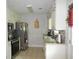 Well-lit kitchen with granite countertops, white cabinets, stainless steel appliances, and tile floors at 770 Starrsville Rd, Covington, GA 30014