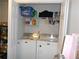 Convenient laundry room with a washer and dryer and shelving at 770 Starrsville Rd, Covington, GA 30014