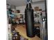 Unique storage room featuring a hanging heavy bag and corner shelving at 770 Starrsville Rd, Covington, GA 30014