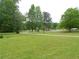 Expansive lawn and peaceful street create a serene outdoor environment at 770 Starrsville Rd, Covington, GA 30014
