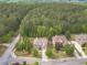 Stunning aerial view of a brick two-story home on a large lot with mature trees and professionally landscaped yard at 882 Nestling Dr, Lawrenceville, GA 30045