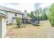 Spacious backyard featuring a screened-in porch, storage shed, and a trampoline at 882 Nestling Dr, Lawrenceville, GA 30045