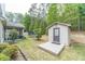 Large backyard with a storage shed, trampoline, screened-in porch, and lush trees at 882 Nestling Dr, Lawrenceville, GA 30045