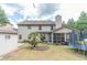 Well-maintained backyard with a small palm tree, a trampoline, and a storage shed at 882 Nestling Dr, Lawrenceville, GA 30045
