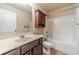 Well-lit bathroom featuring a vanity with storage, a shower-tub combo, and tile flooring at 882 Nestling Dr, Lawrenceville, GA 30045