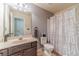 A bathroom featuring a shower over tub, a sink with vanity, and tiled flooring at 882 Nestling Dr, Lawrenceville, GA 30045
