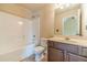 Bathroom with a tub, shower, toilet, vanity, and dark brown cabinets at 882 Nestling Dr, Lawrenceville, GA 30045