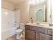 The bathroom features a shower over tub, a sink with a vanity, and neutral decor at 882 Nestling Dr, Lawrenceville, GA 30045