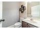 Powder room featuring a modern vanity, floating shelves, and a decorative mirror at 882 Nestling Dr, Lawrenceville, GA 30045