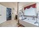 Well-lit bathroom featuring a separate soaking tub and easy access to the home gym at 882 Nestling Dr, Lawrenceville, GA 30045