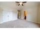 Bright, carpeted bedroom featuring double closets and en-suite bathroom at 882 Nestling Dr, Lawrenceville, GA 30045