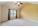 Sun-filled bedroom with vaulted ceilings, plush carpeting, and a large window at 882 Nestling Dr, Lawrenceville, GA 30045